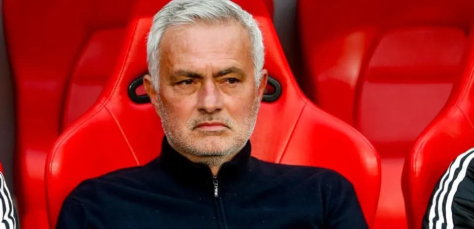 Manager sitting on bench during match