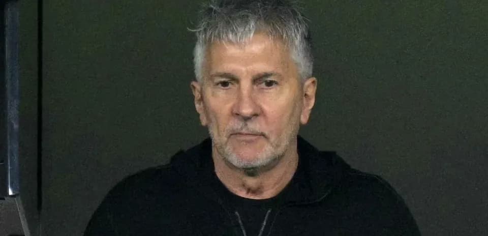 Man in a black hoodie looking directly at camera