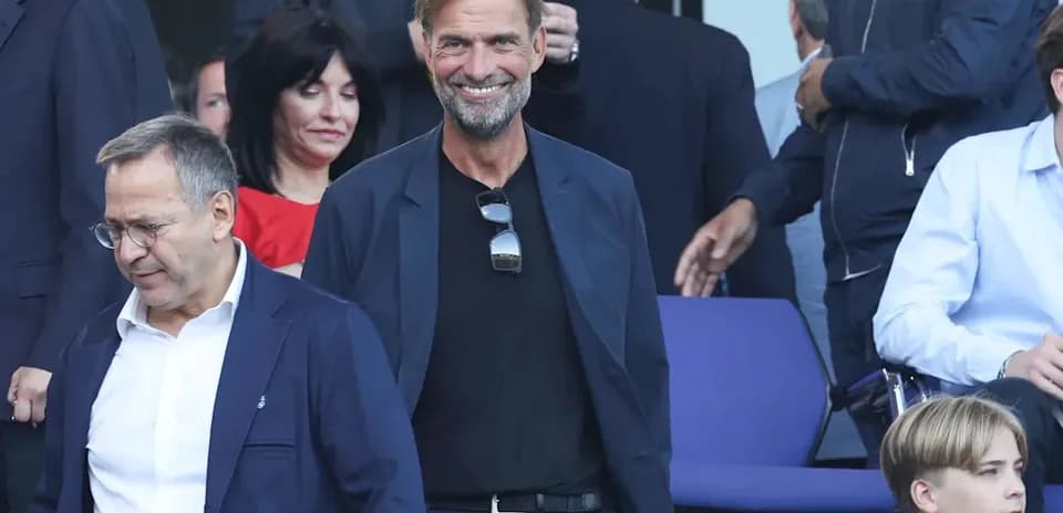 Two men smiling in a crowded venue