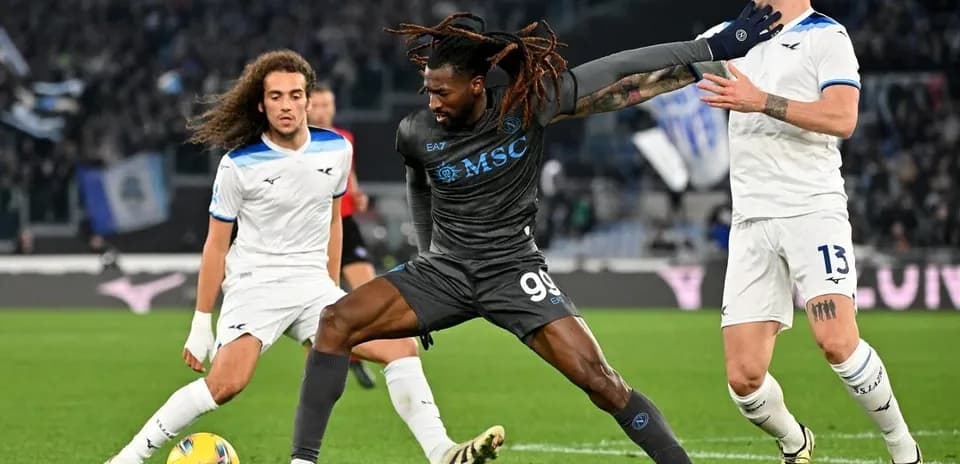 Napoli player battling against Lazio defenders
