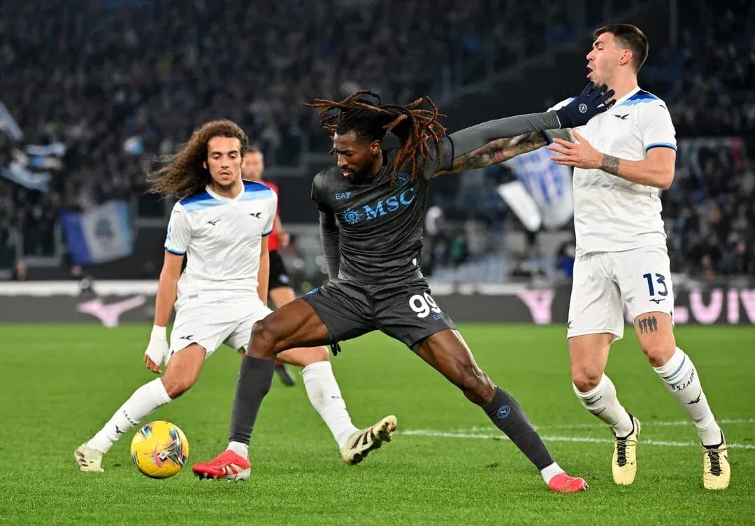 Napoli player battling against Lazio defenders