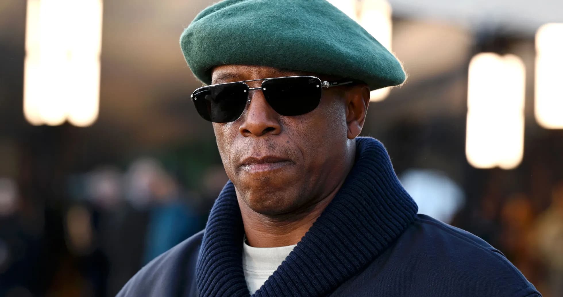 Man wearing a green beret and sunglasses
