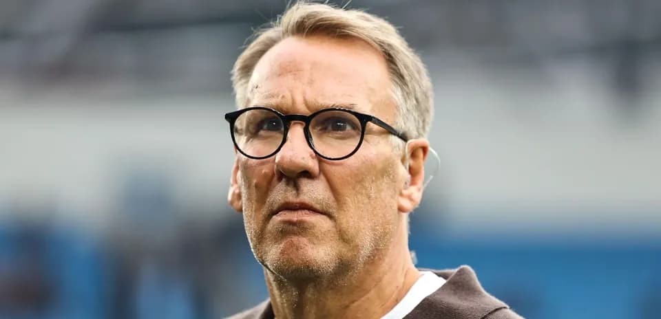 Man with glasses observing the football match