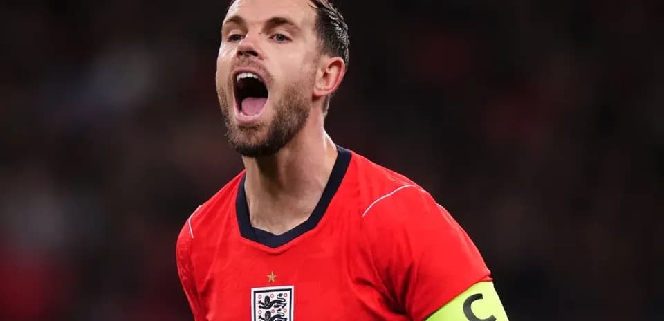 Player celebrating in red England jersey with captain's armband