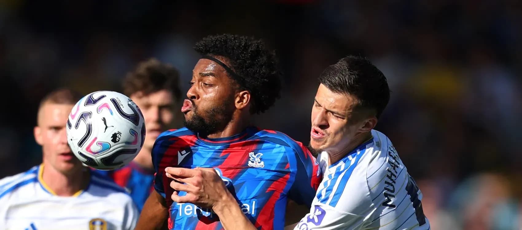 Two players contesting for the ball during match