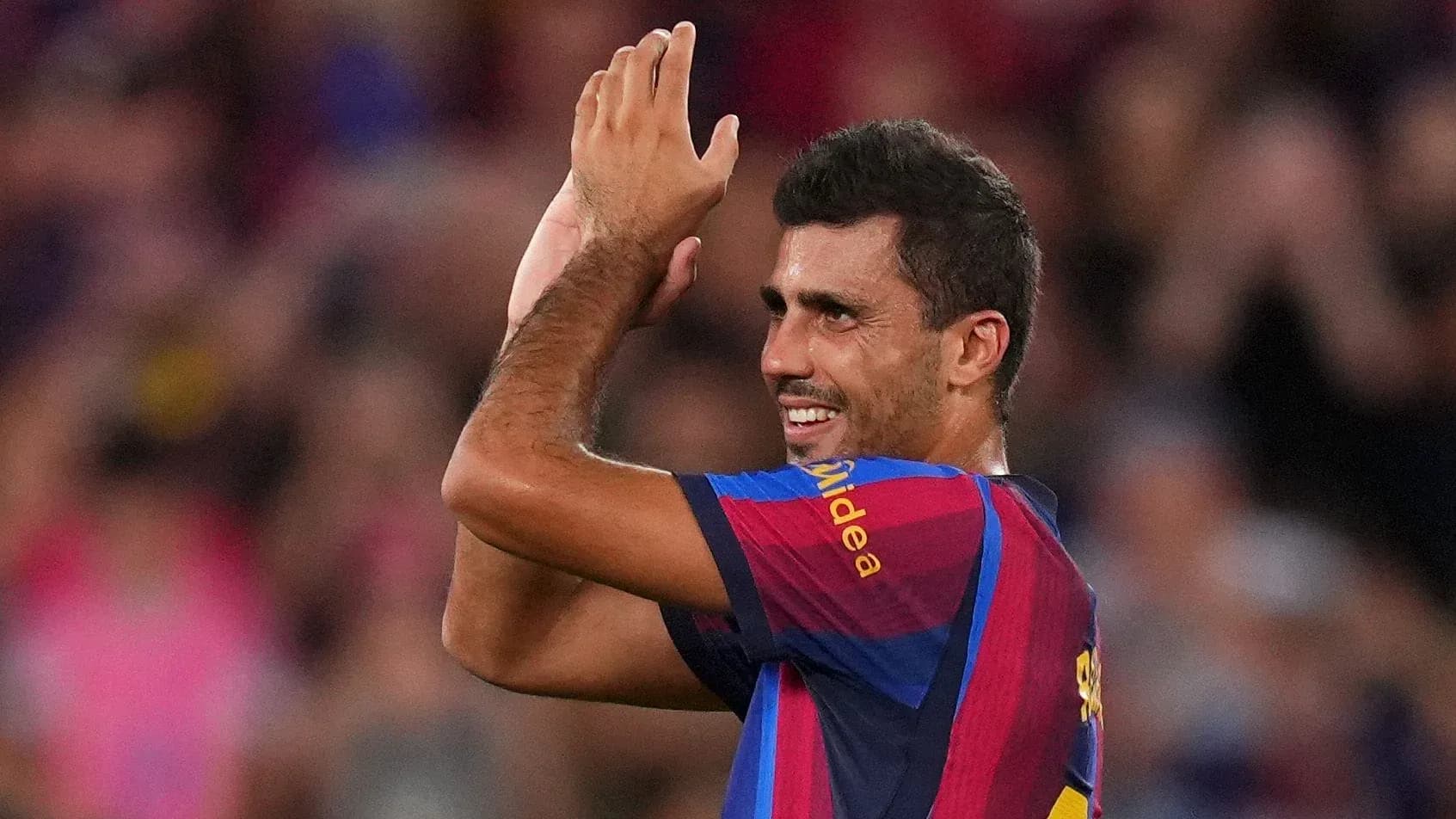 Player applauding fans during match at stadium