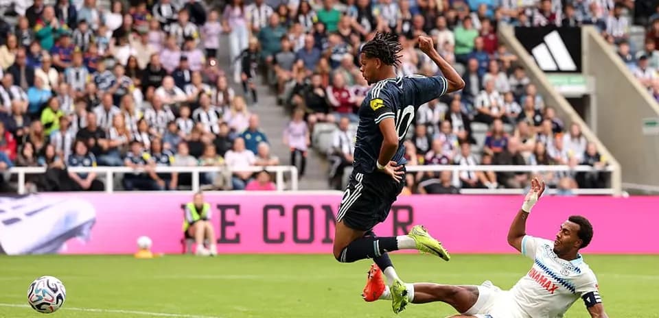 Player jumping over opponent during a soccer match