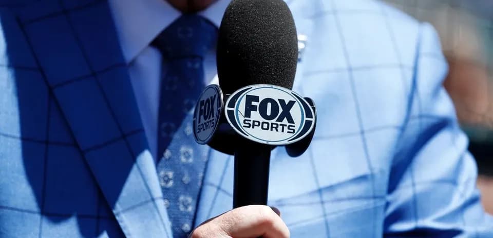 Microphone with FOX Sports logo held by announcer