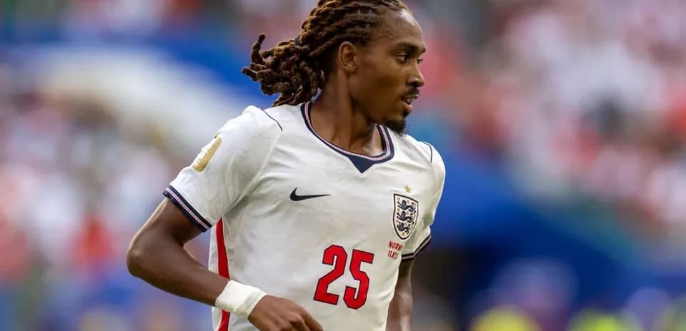 Player in England jersey running during match