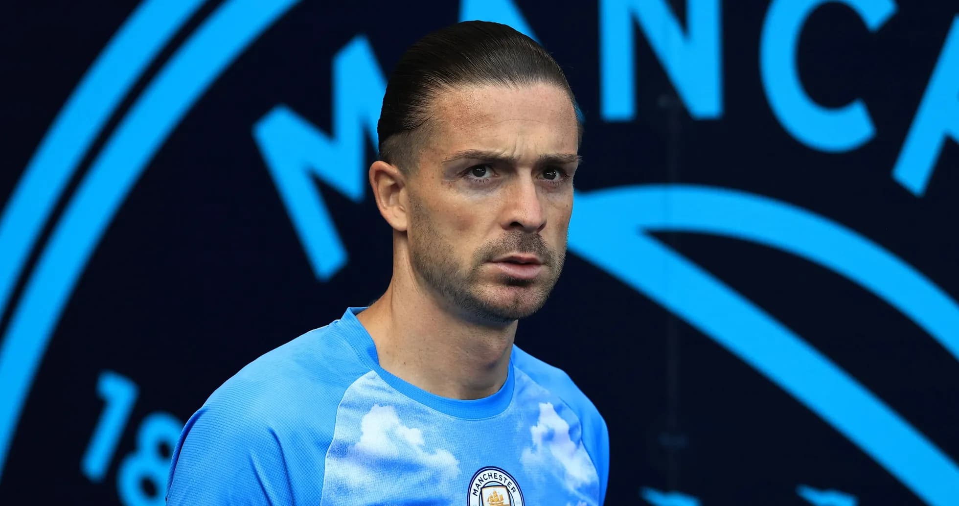 Player in Manchester City training kit on pitch
