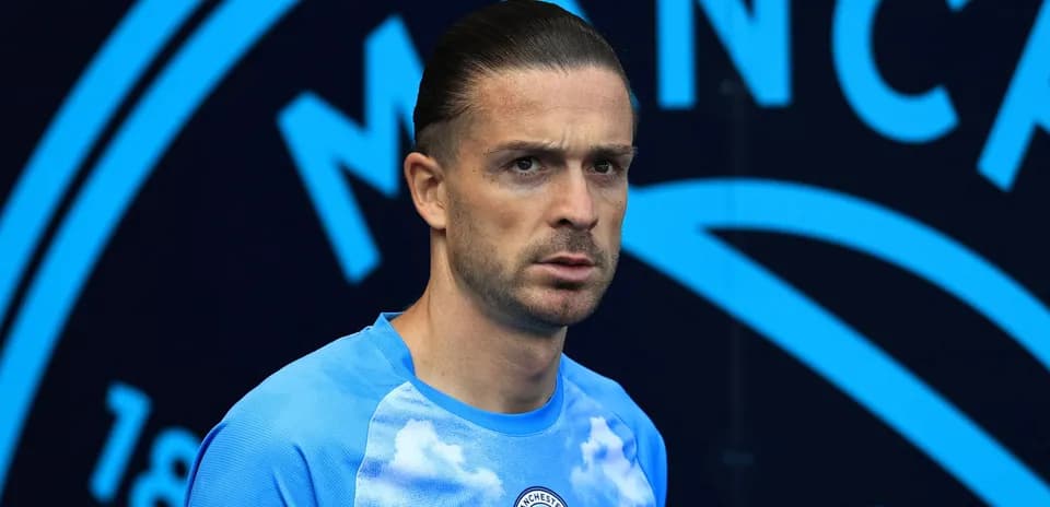 Player in Manchester City training kit on pitch