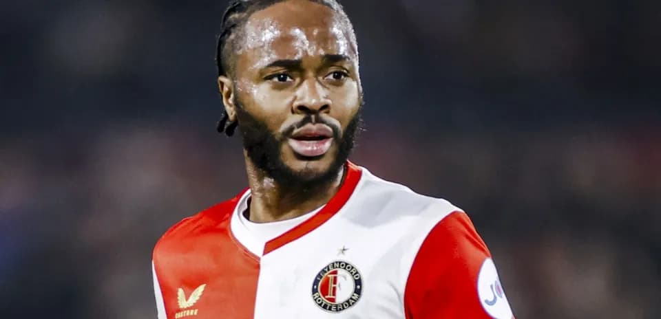 Feyenoord player in red and white kit on field