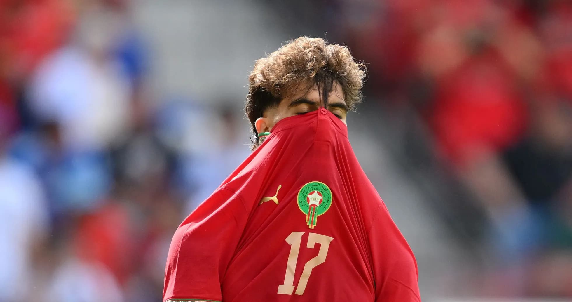 Player pulling shirt over head during match