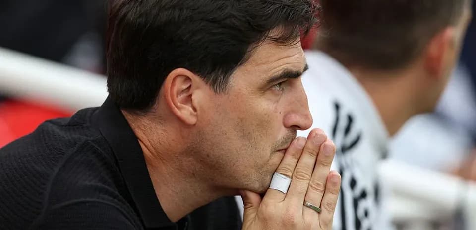 Coach deep in thought during a match