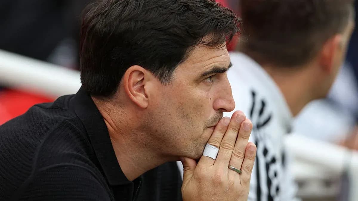 Coach deep in thought during a match