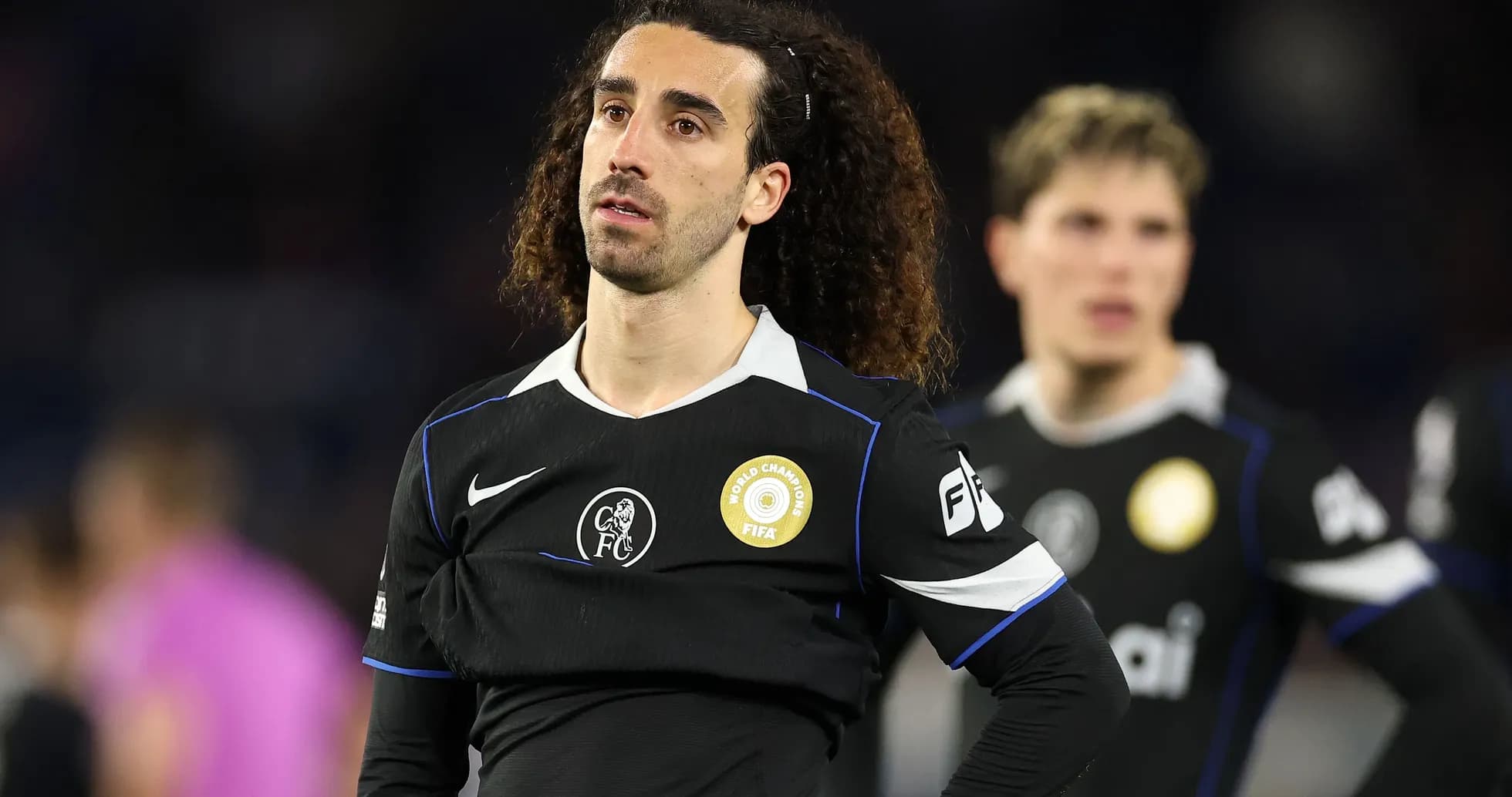 Player in black jersey during match with teammates