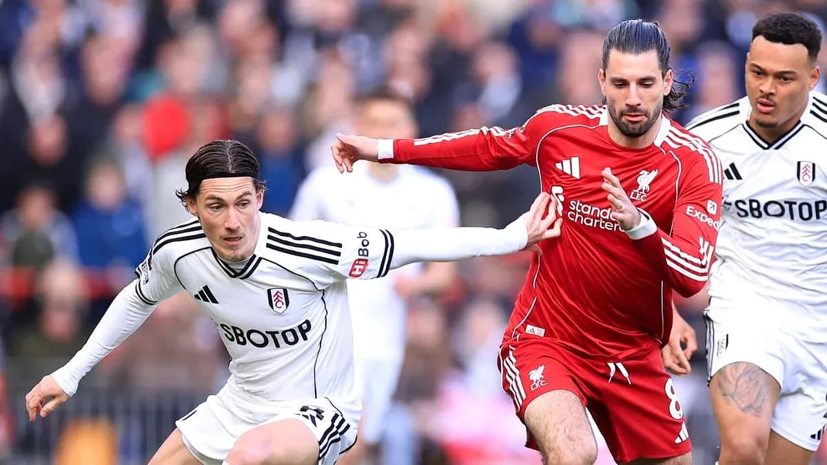 Fulham and Liverpool players competing for possession