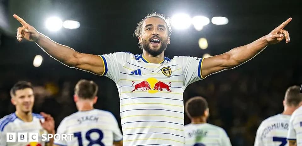 Player celebrating goal with teammates in background