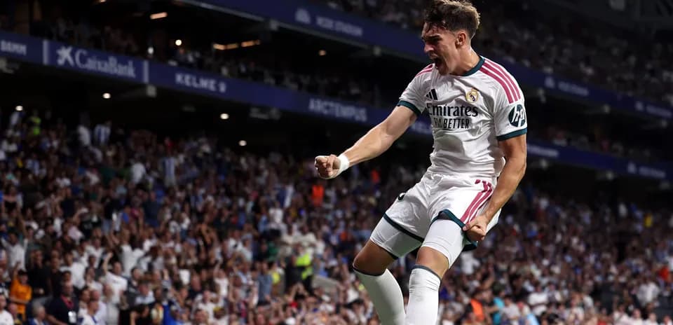 Player celebrating a goal in front of fans