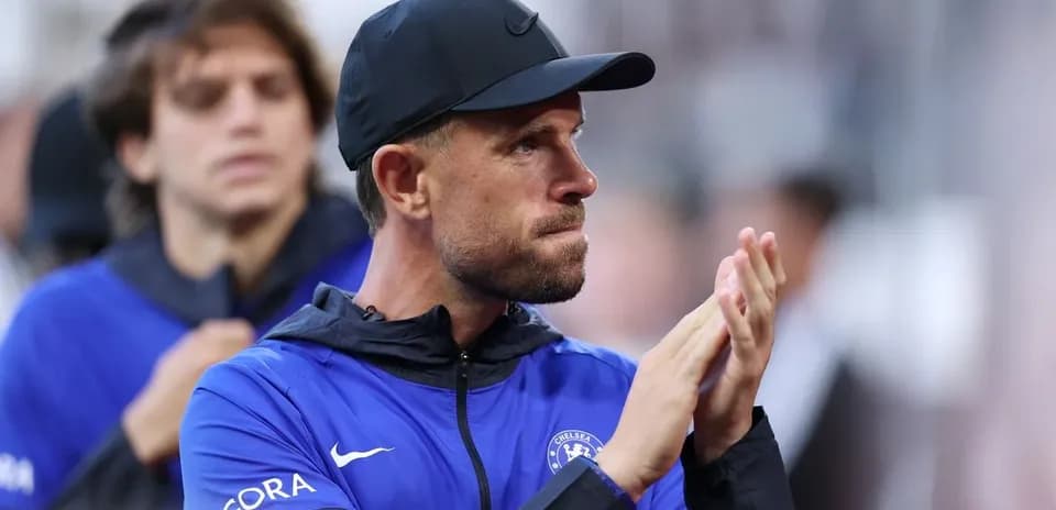 Coach applauding during match with team in background