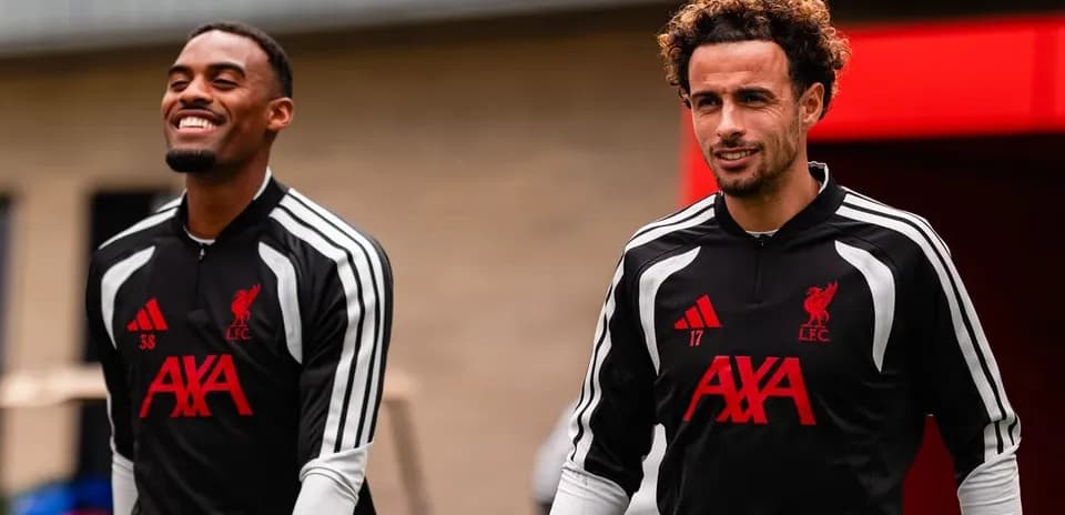 Two Liverpool players arriving for training session