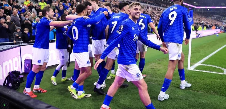 Everton players celebrating a goal on the pitch