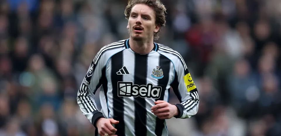Player wearing Newcastle United kit on the pitch
