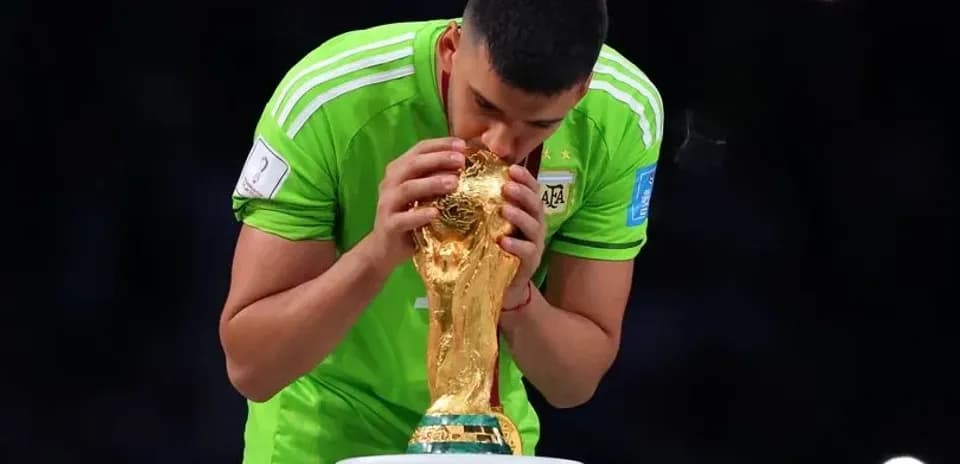 Goalkeeper kissing FIFA World Cup trophy
