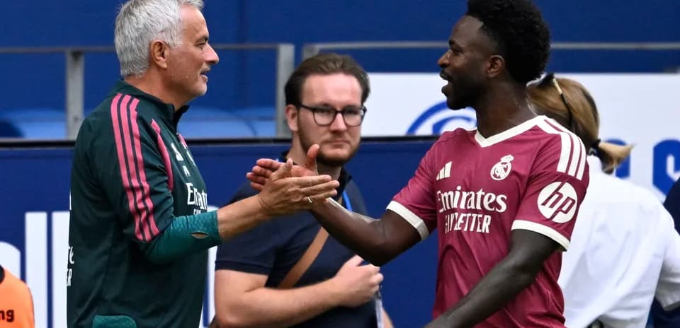 Manager and player shaking hands on the pitch