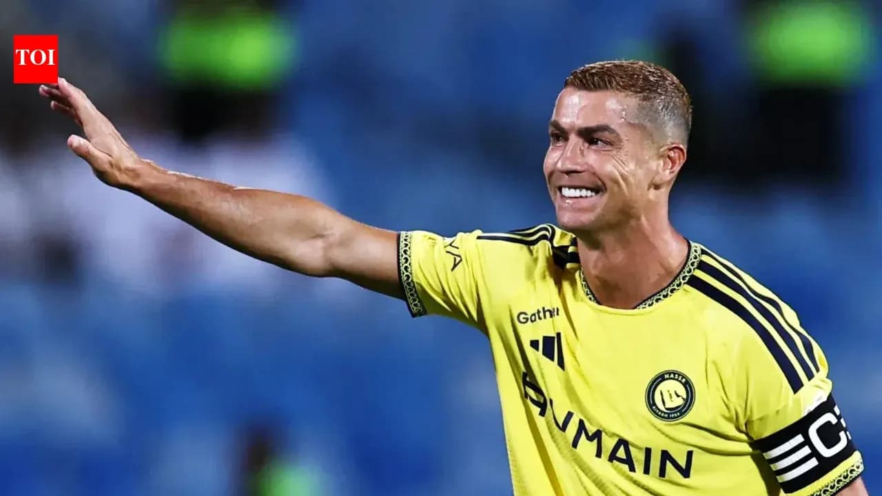 Player waving while wearing yellow team jersey