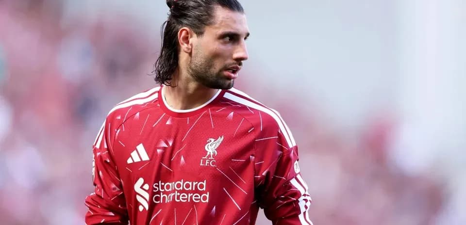 Goalkeeper wearing Liverpool jersey during match