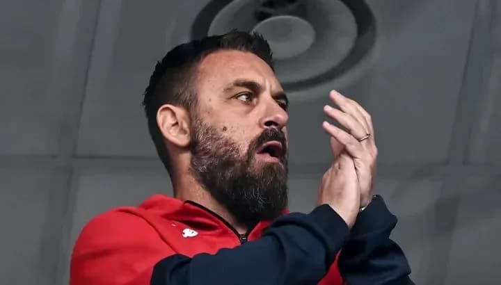 Man clapping in a sports venue stands