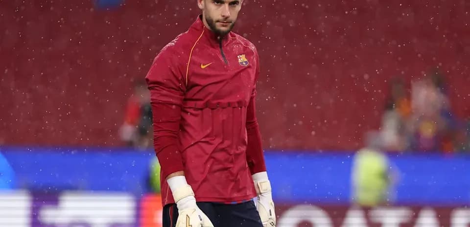 Goalkeeper warming up during rainy match conditions