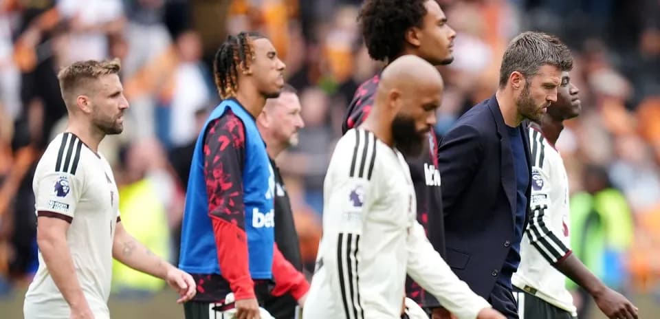 Players and staff leaving the pitch after match
