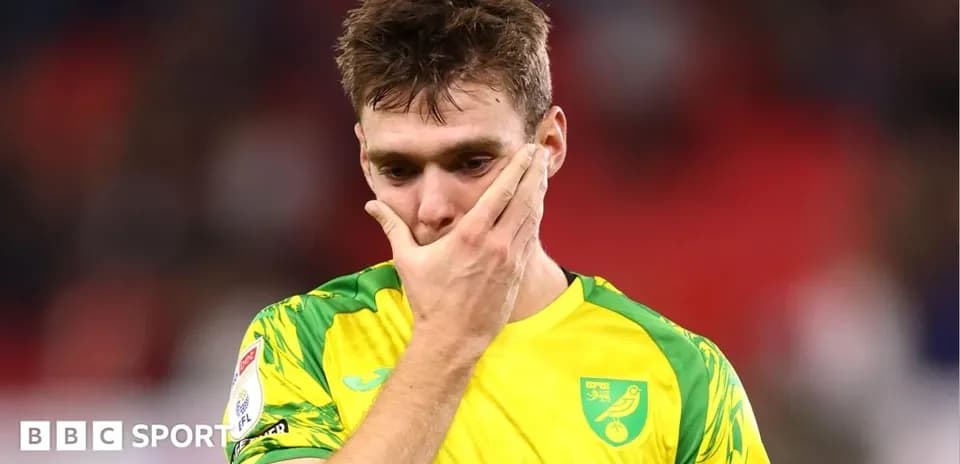 Player in yellow jersey looking pensive on field