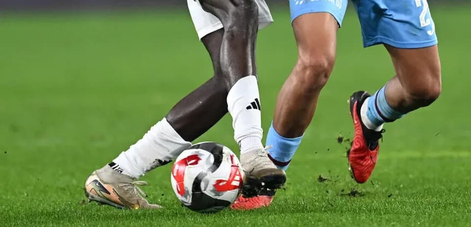 Two players challenging for the ball during match