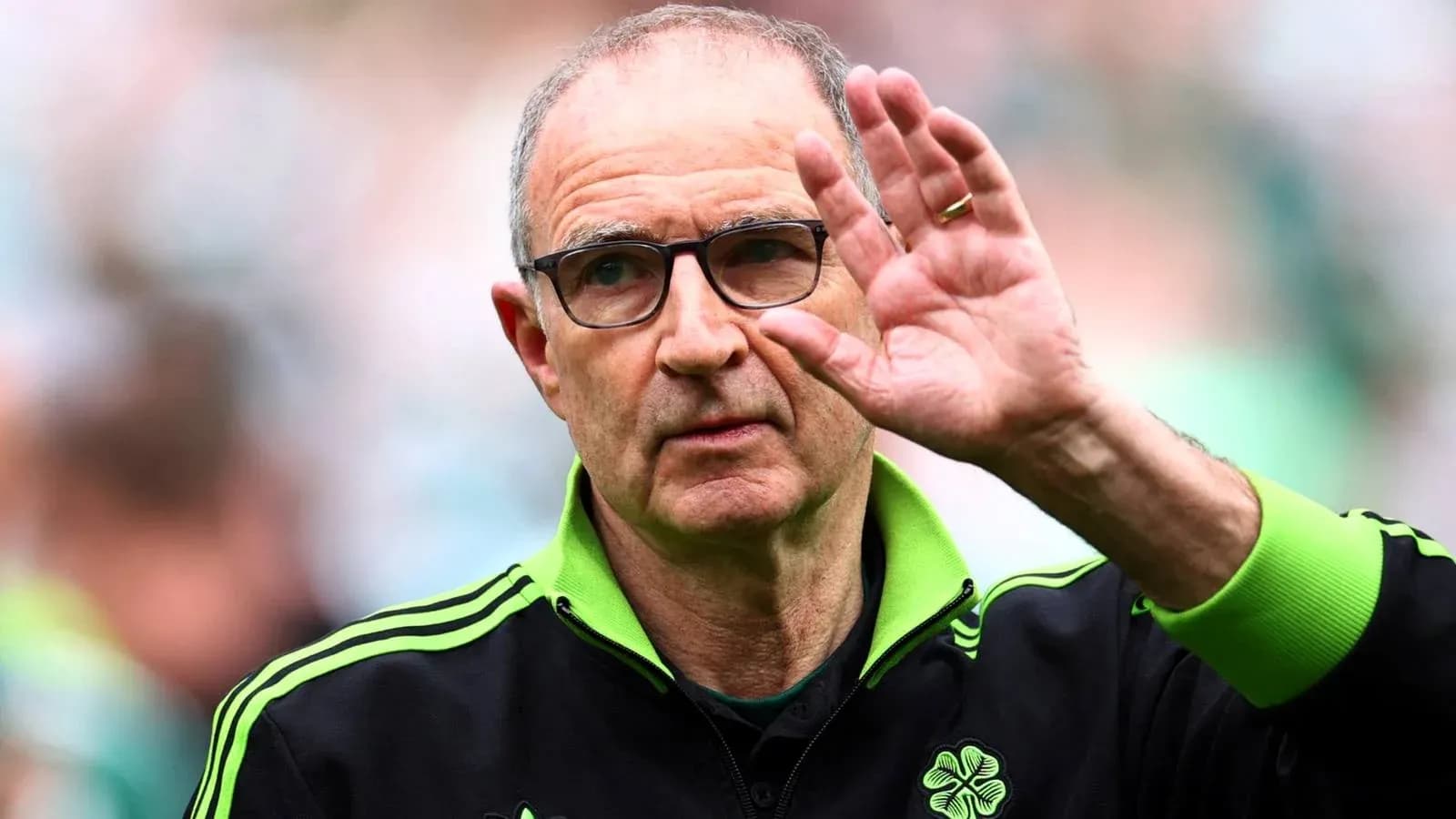 Manager waving to fans during match
