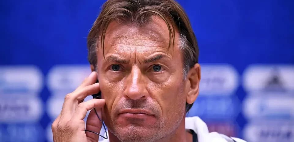 Coach speaking into headset at press conference