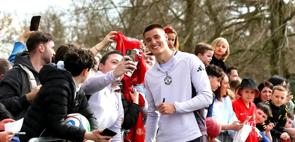 Player taking selfie with fans at event
