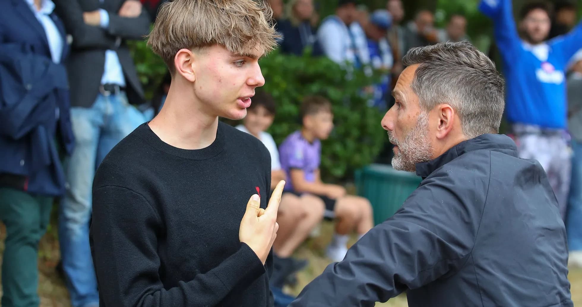 Two individuals engaged in conversation at event