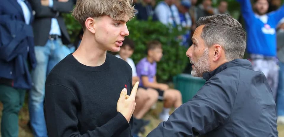 Two individuals engaged in conversation at event
