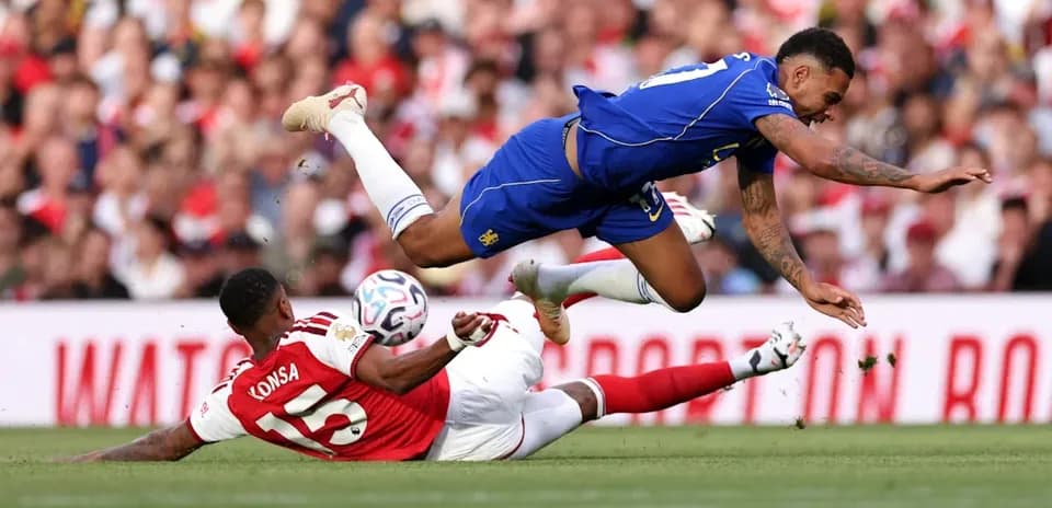 Player falling over another during a football match