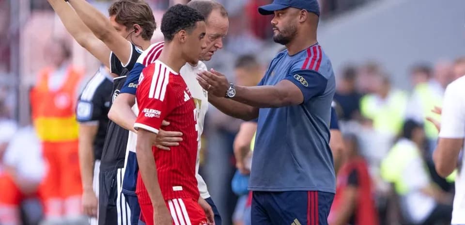Player receiving guidance from coach during substitution