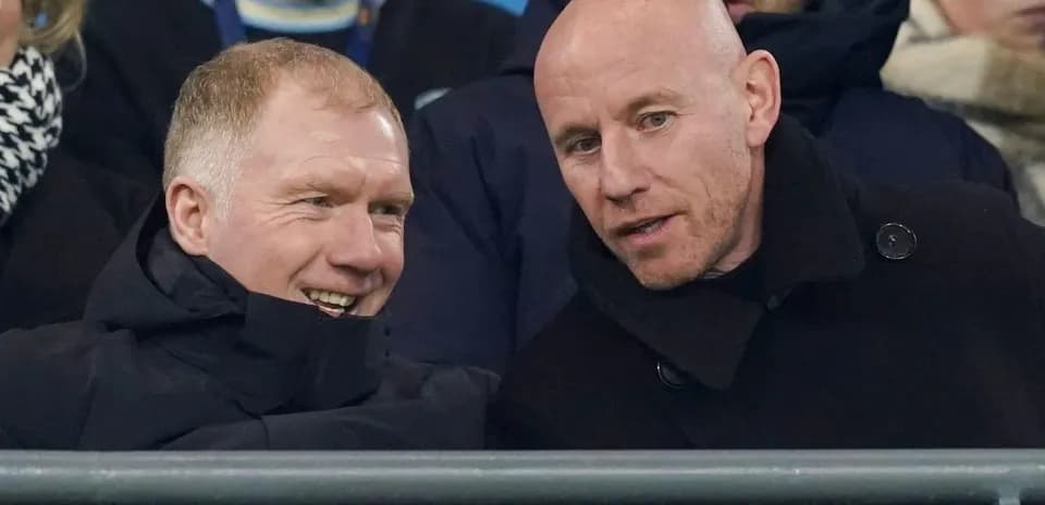 Two men conversing in stadium seats