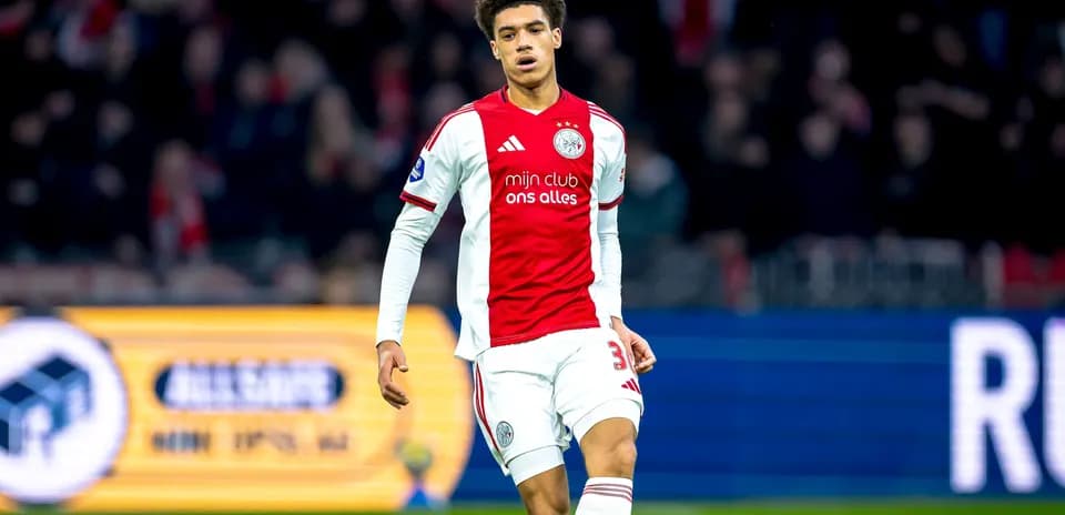 Player in Ajax jersey walking on the pitch