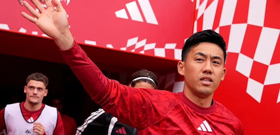 Player waving while exiting tunnel at stadium