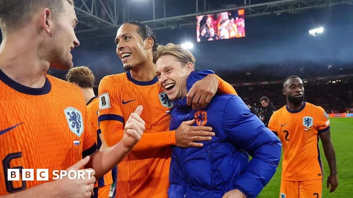 Players celebrating after a match in orange jerseys