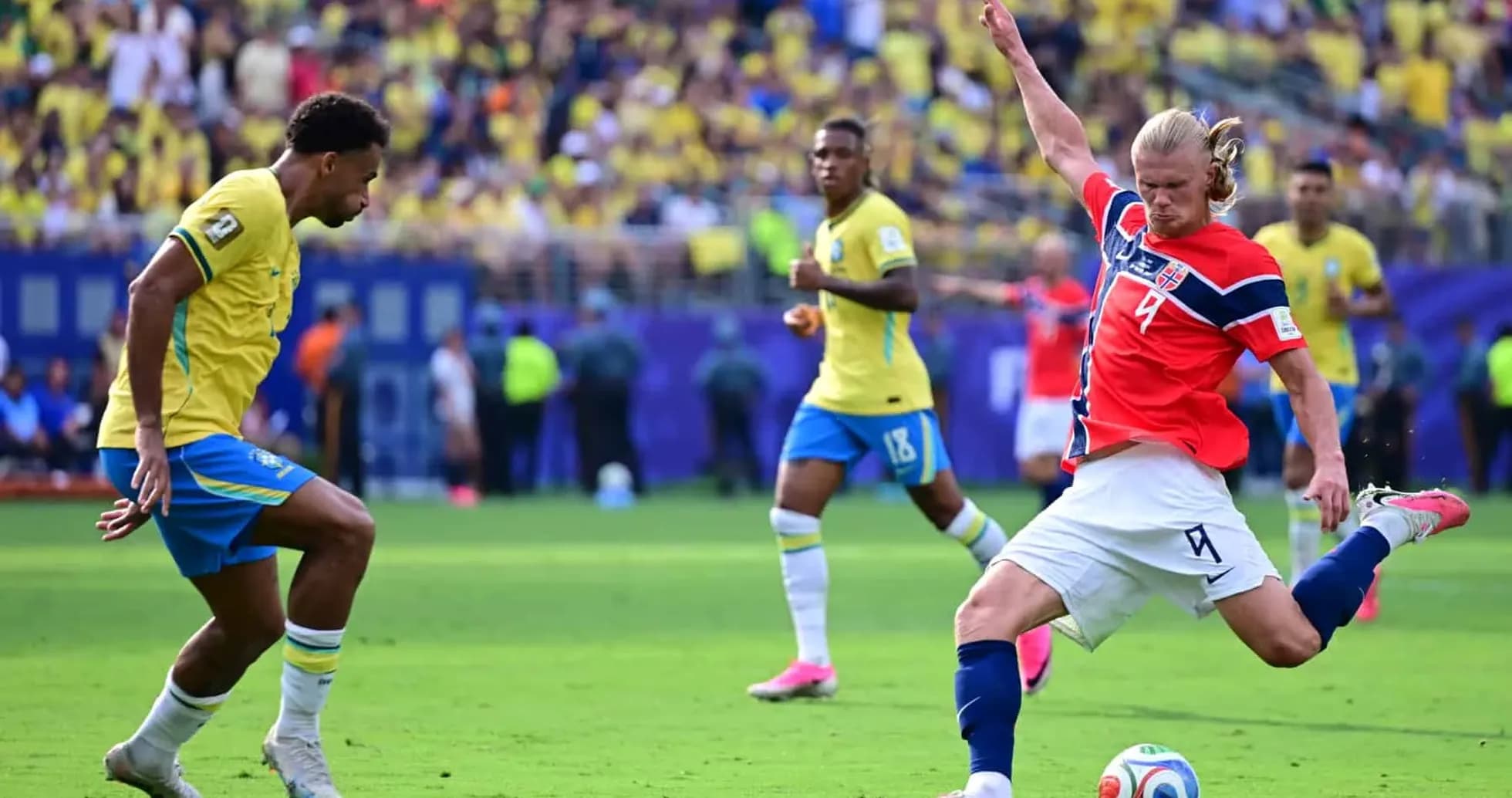 Brazil player tackling Norway opponent during match