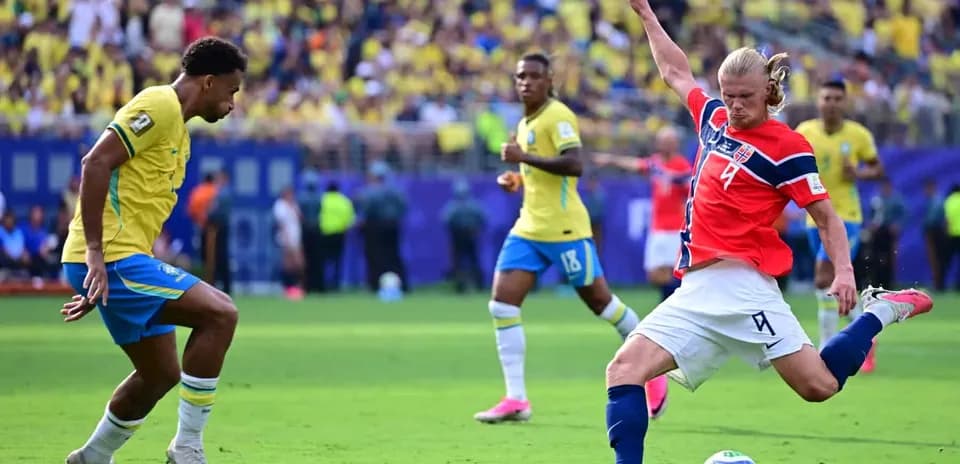 Brazil player tackling Norway opponent during match