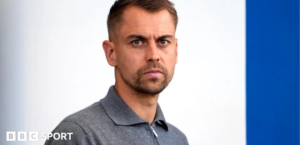 Man in gray polo shirt posing for photo
